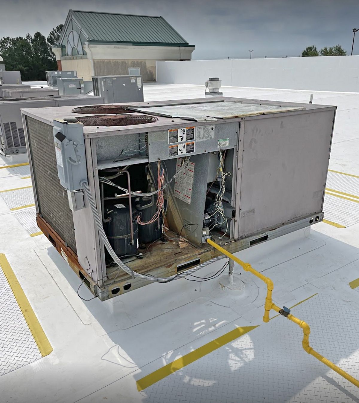 A commercial rooftop unit with its service panels off