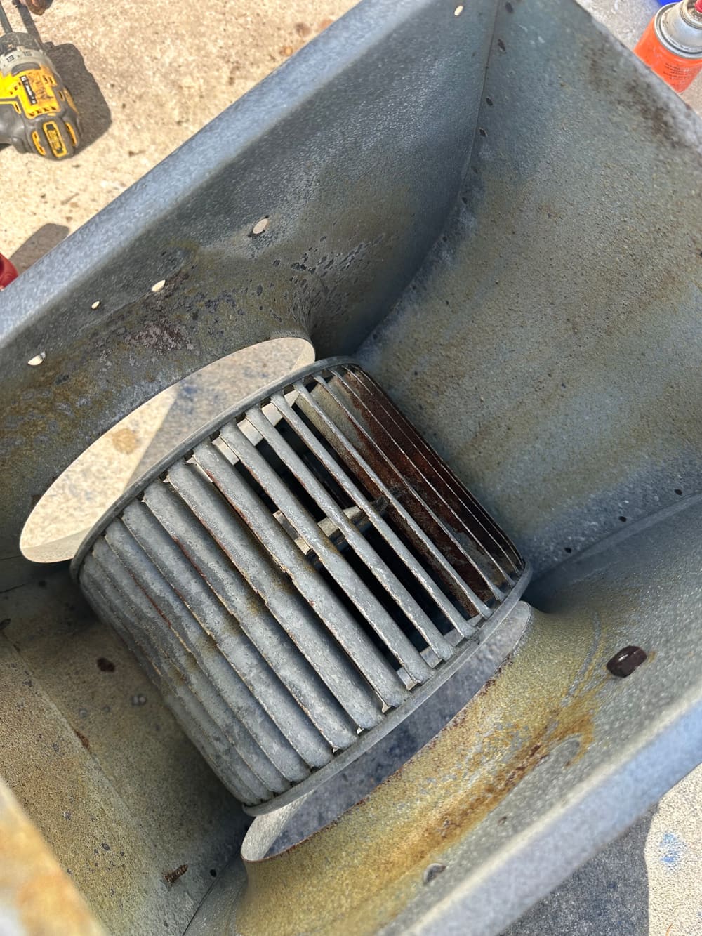 Blower wheel inside an air handler cabinet during cleaning