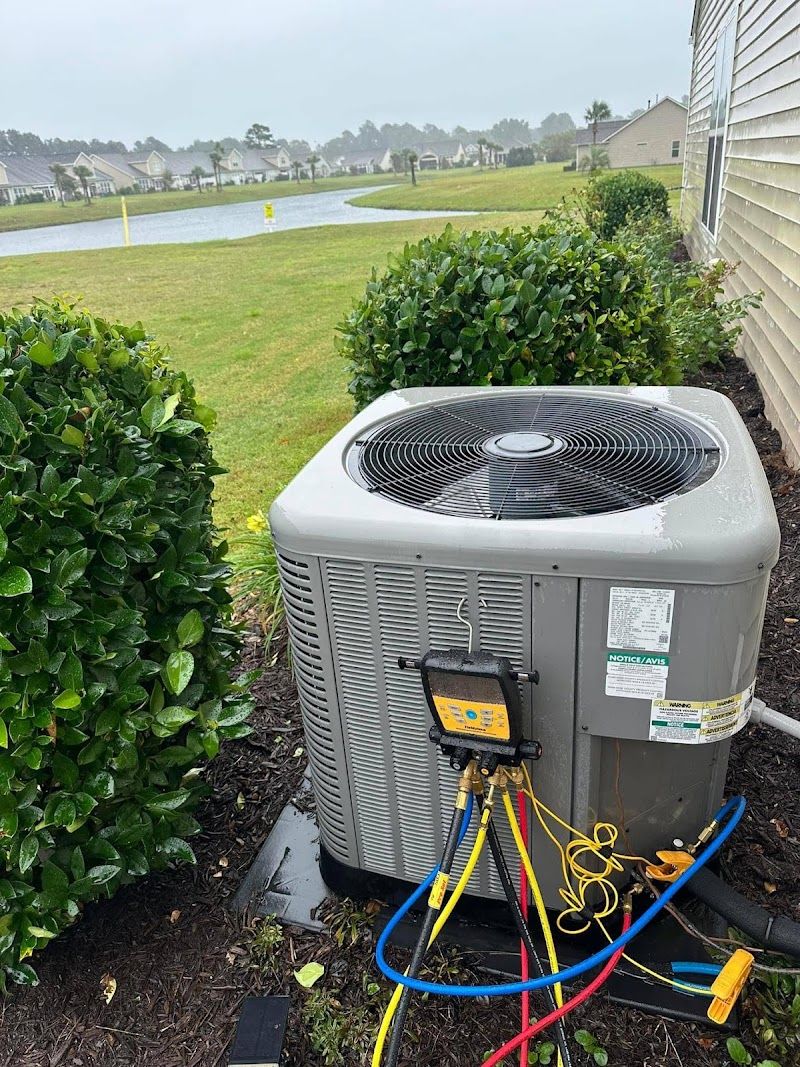 Condenser beside a house on a pond
