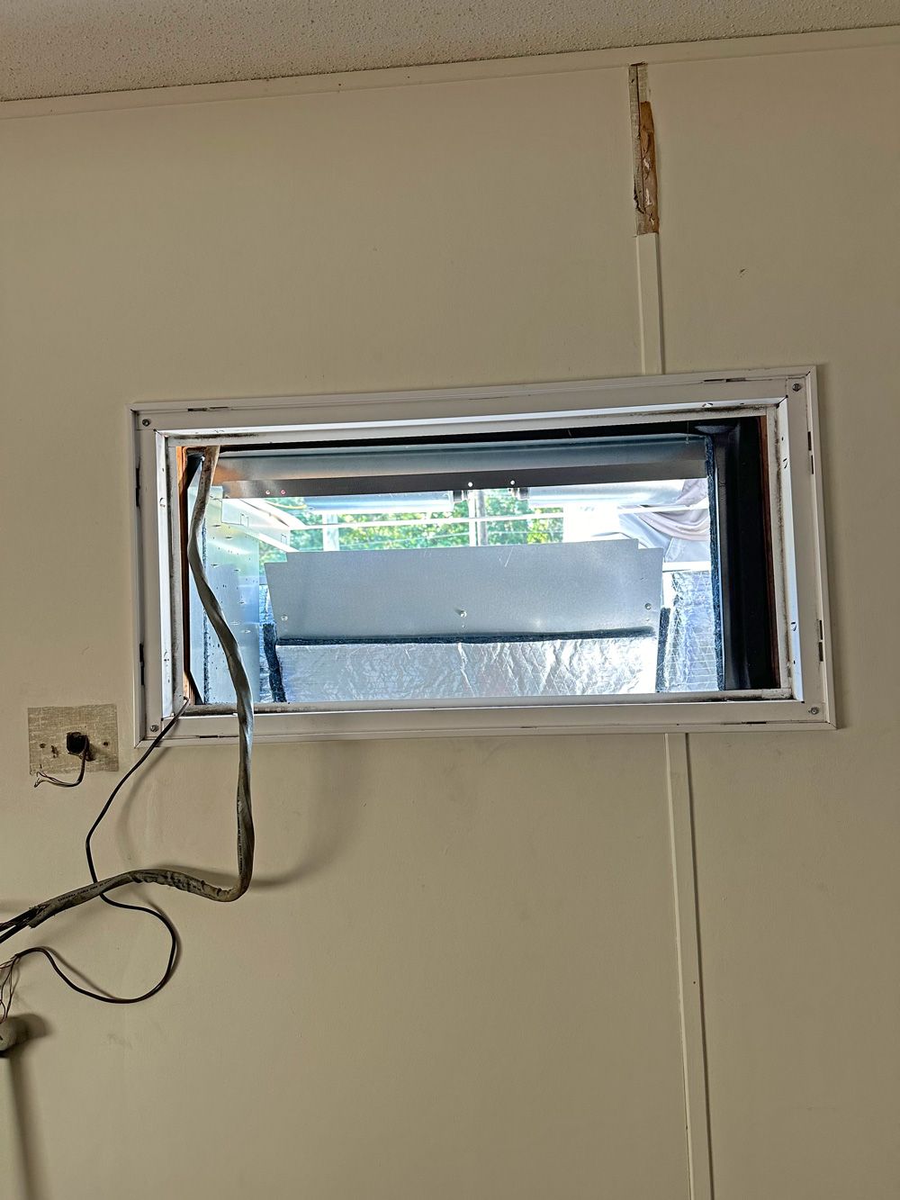 Inside view of the wall sleeve opening and wiring during the wall unit swap
